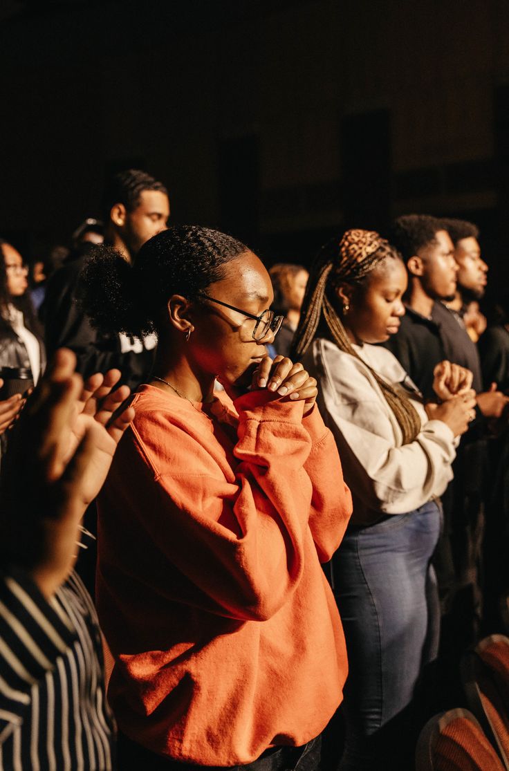 Young people praying during worship